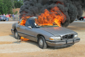 Car burning live on a ground